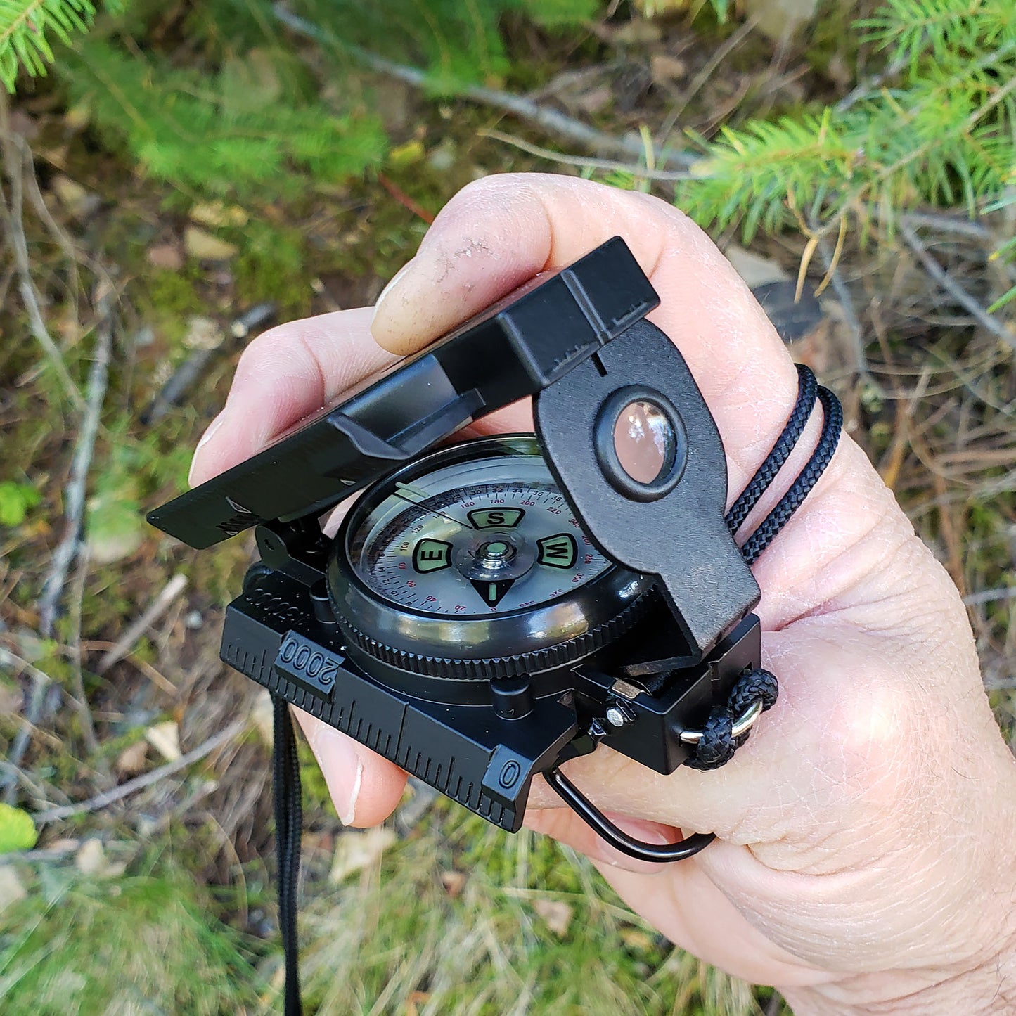 how to hold a lensatic compass