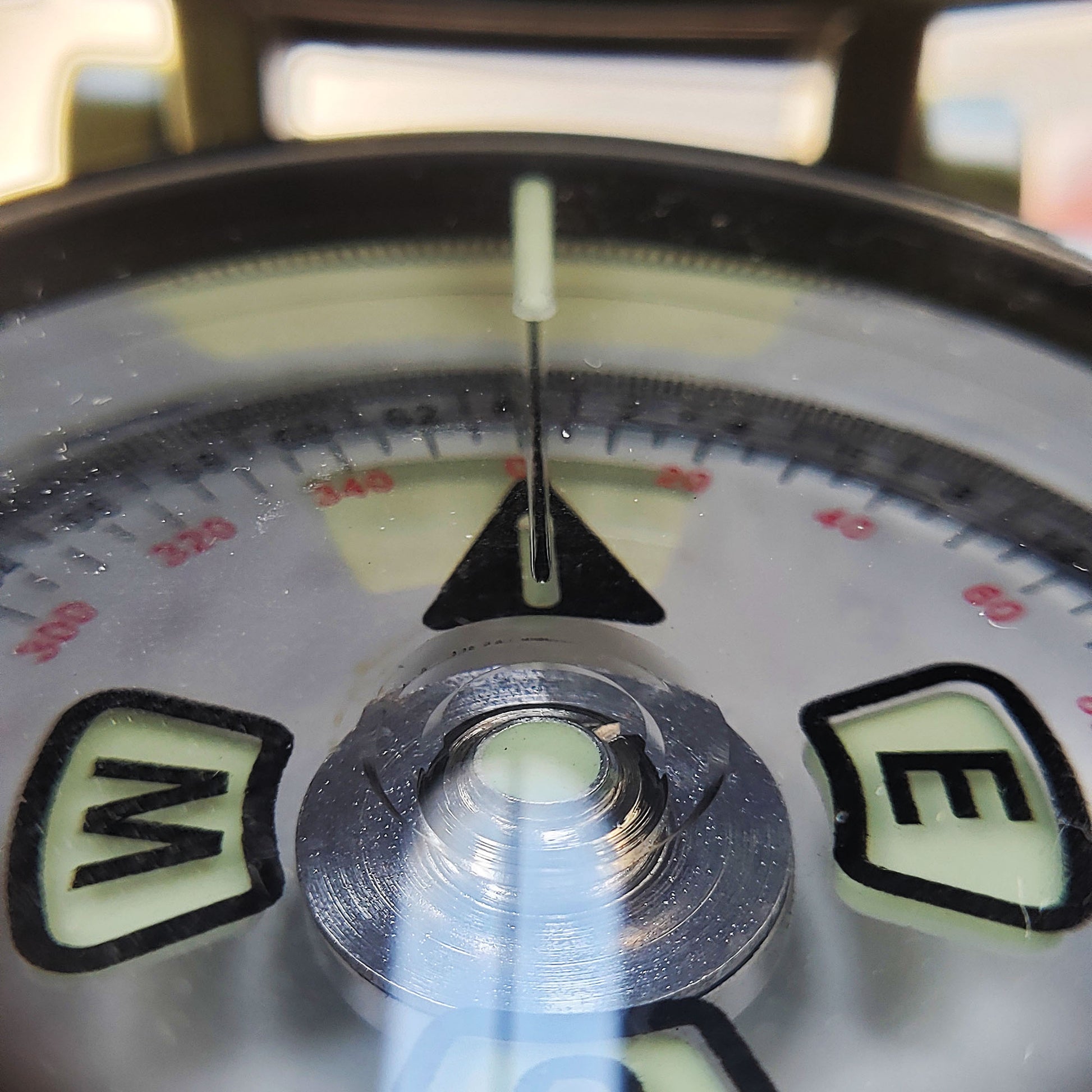 looking through a lensatic compass